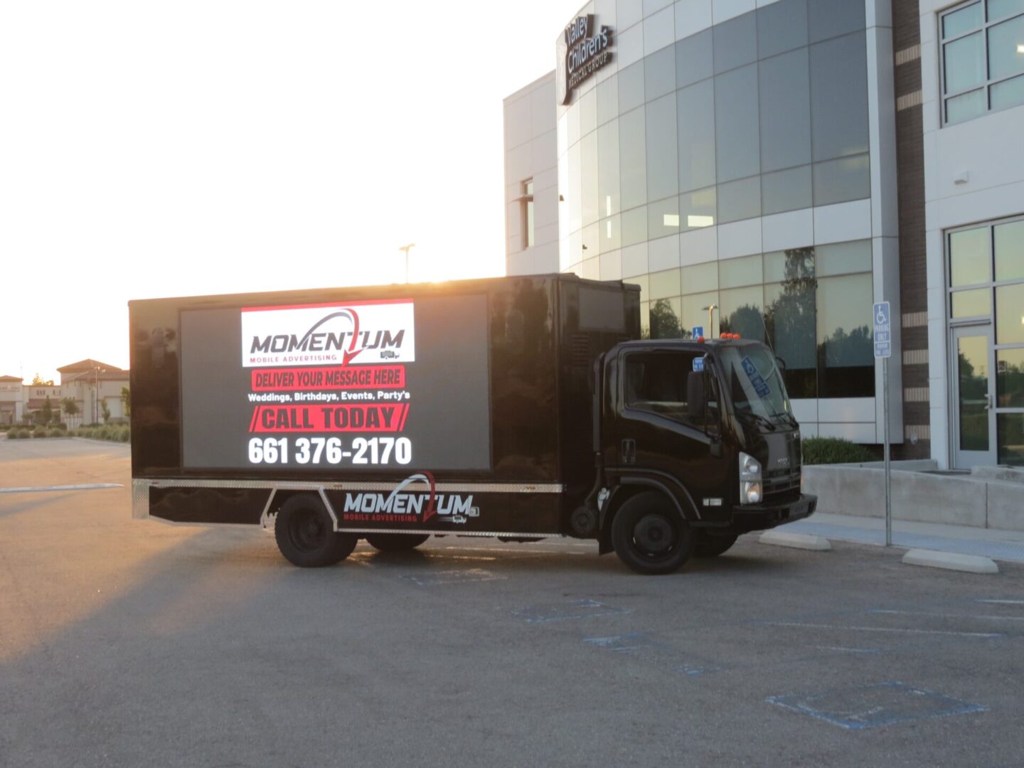 A truck with a sign on the back of it.